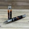 Large rollerball pen with orange, black, and purple epoxy